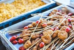 Catering trays of grilled shrimp and vegetable skewers