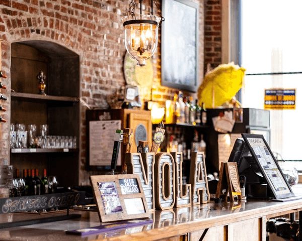 The Fleur de Lis Bar at Blue Orleans with exposed brick and pendant lighting