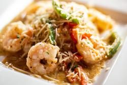 Grilled shrimp over cheese grits with cream sauce