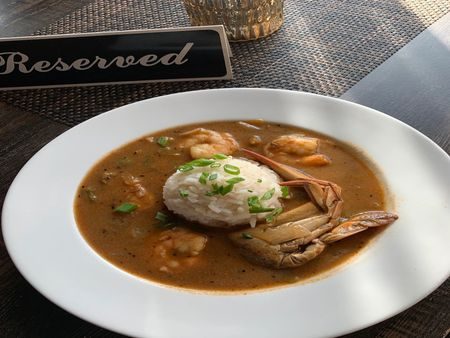 Bowl of seafood gumbo topped with white rice